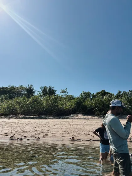 Guide explaining beside a tide pool at low tide