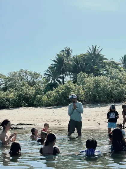 Children in a tide pool listening to their guide