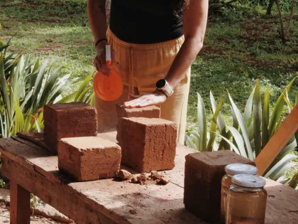 Hands shaping adobe blocks