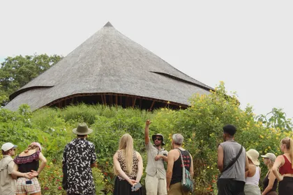Group gathered under a maloca roof at Tierramor